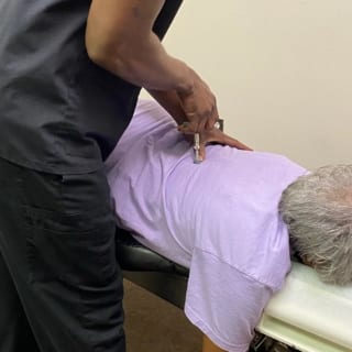 Using one of our professional toosl to help relieve pressure in a patient's spine.
