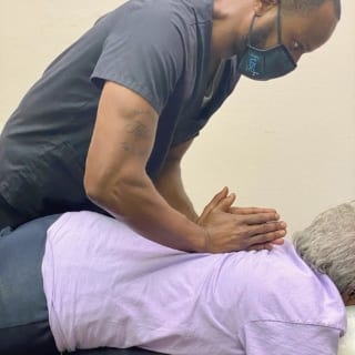 The doctor utilizes massage to help work out the stress for a patient.
